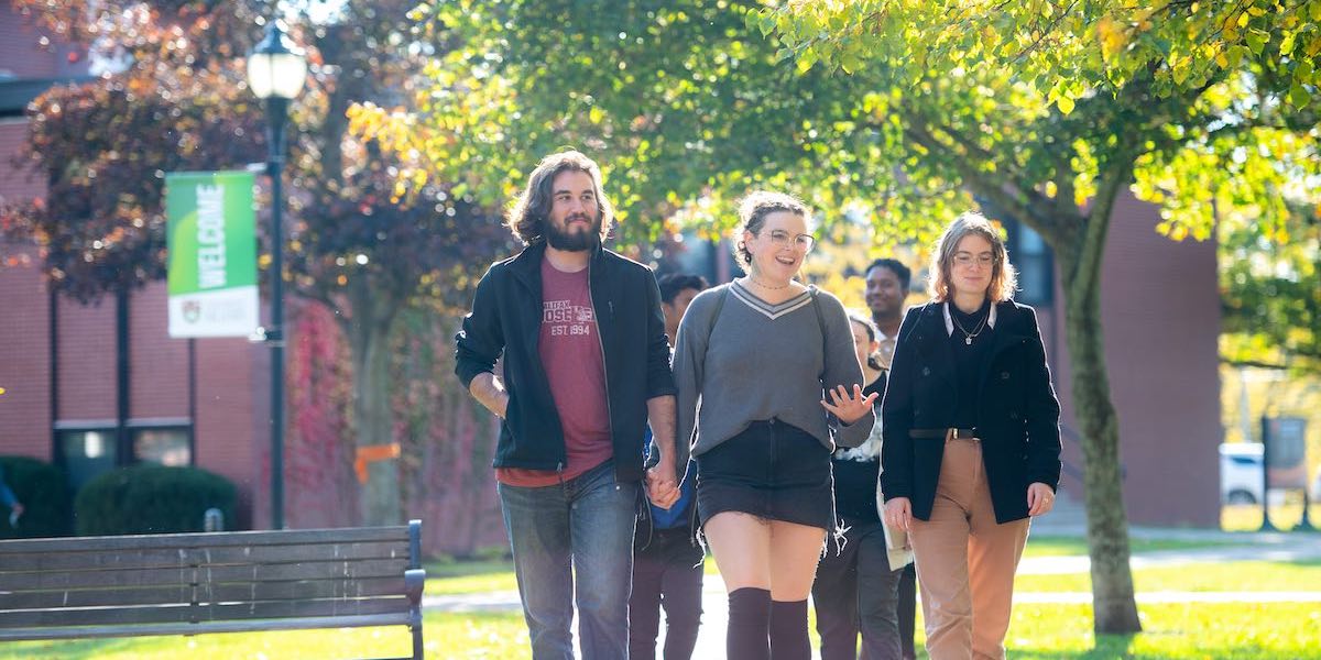 a group of students walking in ͯŮ's quad in fall